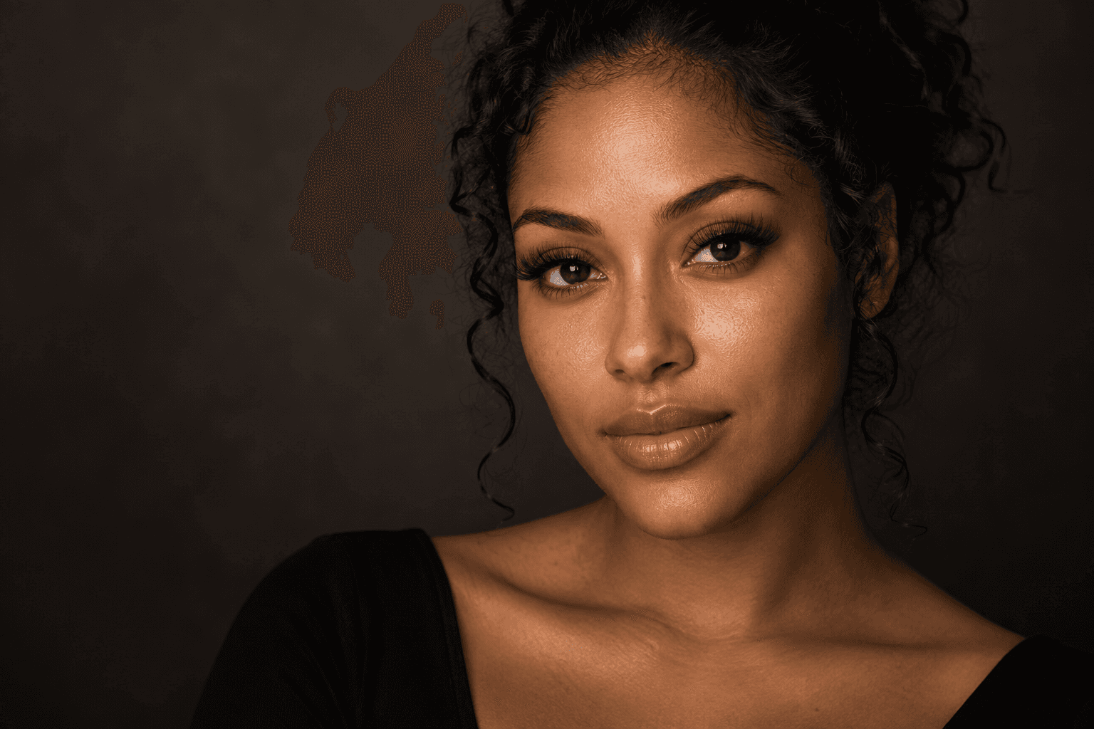 An editorial beauty portrait with softly textured lash extensions and natural skin detail